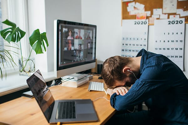 how to motivate for photographers blog image man with head on desk in front of computer